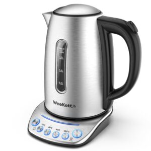 A tall cylindrical silver plastic Kettle with a Black Plastic Handle that has WeeKett written in bold black writing on it on top of a large circular metallic silver base that has six silver buttons and some bright blue lights on it, on a white background.