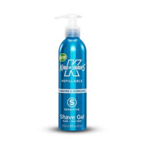 A tall cylindrical metallic light blue bottle with a clear plastic pump lid that has King of Shaves Refillable Sensitive Shave Gel written in bold white writing on it, on a white background.