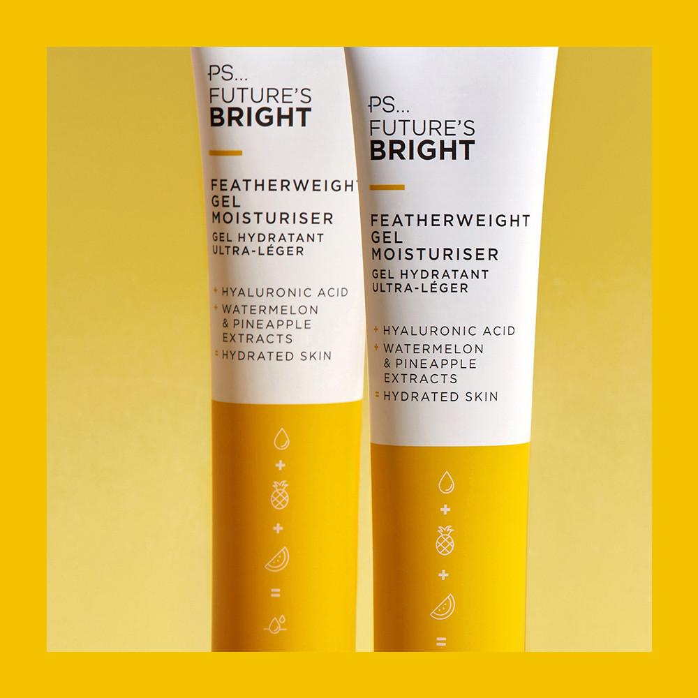 A long thin conical white plastic tube with a white plastic lid that has Primark PS Futures Bright Featherweight Gel Moisturiser written in bold black writing and a picture of a bright yellow stripe on it, on a white background.