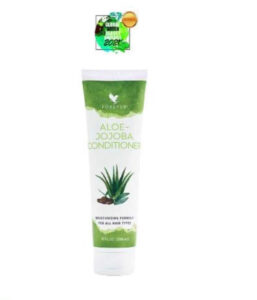 A tall cylindrical White Plastic Bottle with a white plastic lid and a white label that has Forever Living Aloe Jojoba Conditioner written in bright green writing and some pictures of some large dark green aloe vera leaves on it, on a white background.
