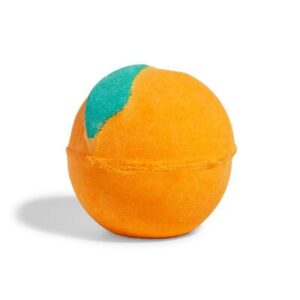 A large bright orange rounded hexagonal shaped bath bomb that has a dark green 3d leaf on top of it, on a white background.