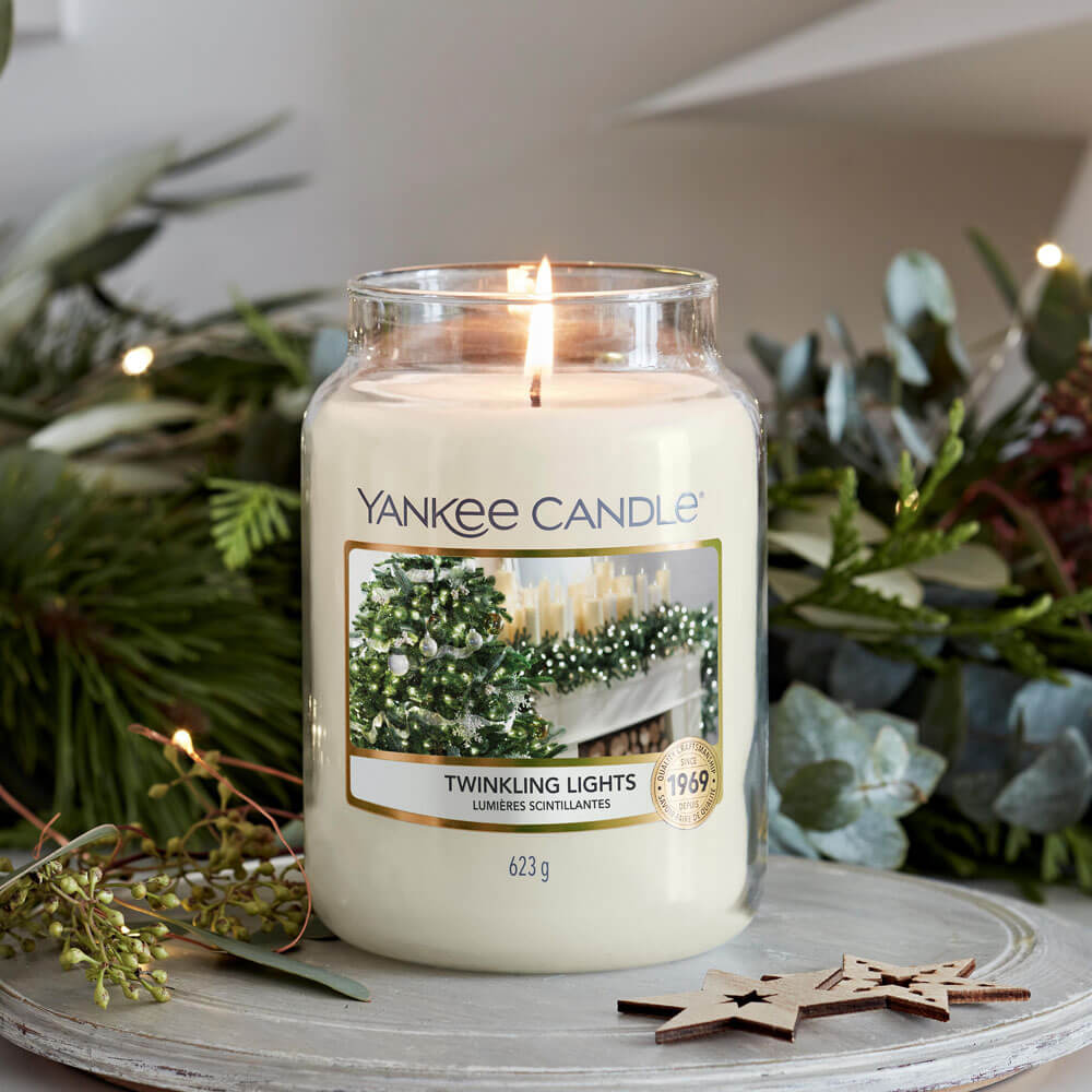 What I Thought of the Yankee Candle Advent House 2014 A tall cylindrical glass jar full of some bright white wax with a label that has Yankee Candle written in white writing, Twinkling Lights written in black writing, and a picture of some bright white twinkling fairy lights on it, on a white background.
