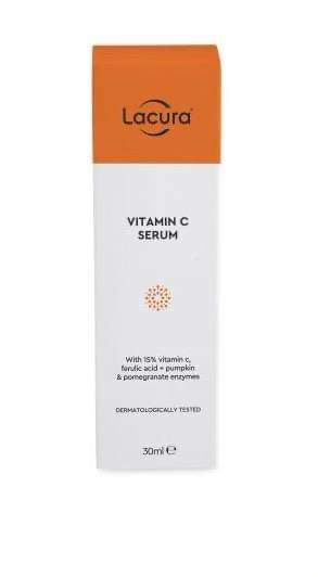 I'm Just Nipping To The Supermarket For Some Glowing Skin | Aldi Lacura Glycolic Serum & Vitamin C Serum A tall rectangular cardboard box that has Aldi Lacura Vitamin C Serum written in bold black writing and a picture of a light orange stripe on it, on a white background.
