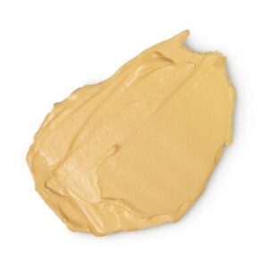 A medium circular puddle of bright golden yellow hand balm, on a white background.