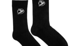 A pair of crew length black bamboo socks that have a picture of a white open winged swallow inside two white circles on it, on a white background.