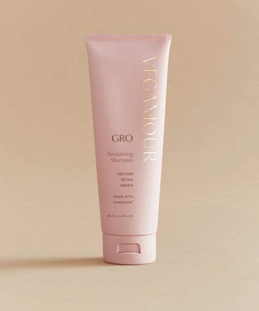 Growing My Hair From The Things That I've Found In My Garden | Vegamour Grow Haircare Range | Gifted A tall conical bright pink Plastic Tube with a bright pink lid that has Vegamour Grow Revitalising Shampoo written in bold gold writing on it, on a white background.