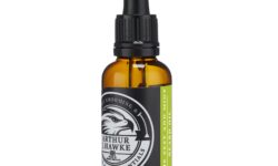 A short cylindrical brown glass bottle with a black rubber pipette lid and a white label that has Arthur J Hawke Lime Zest & Mint Beard Oil written in bold white writing and a picture of a black and white hawk on it, on a white background.