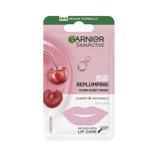 The Taste Of Her Cherry Lip Mask | Garnier Moisture Bomb Cherry Lip Tissue Mask A long and thin gradient pink and white plastic pouch that has Garnier Moisture Bomb Cherry Lip Tissue Mask written in bold black writing and some pictures of some bright red cherries and some bright red lips on it, on a white background.