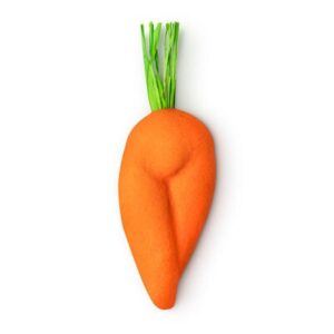 A large bright orange carrot shaped bubble bar that has some pieces of bright green raffia coming out of the top of it, on a white background.