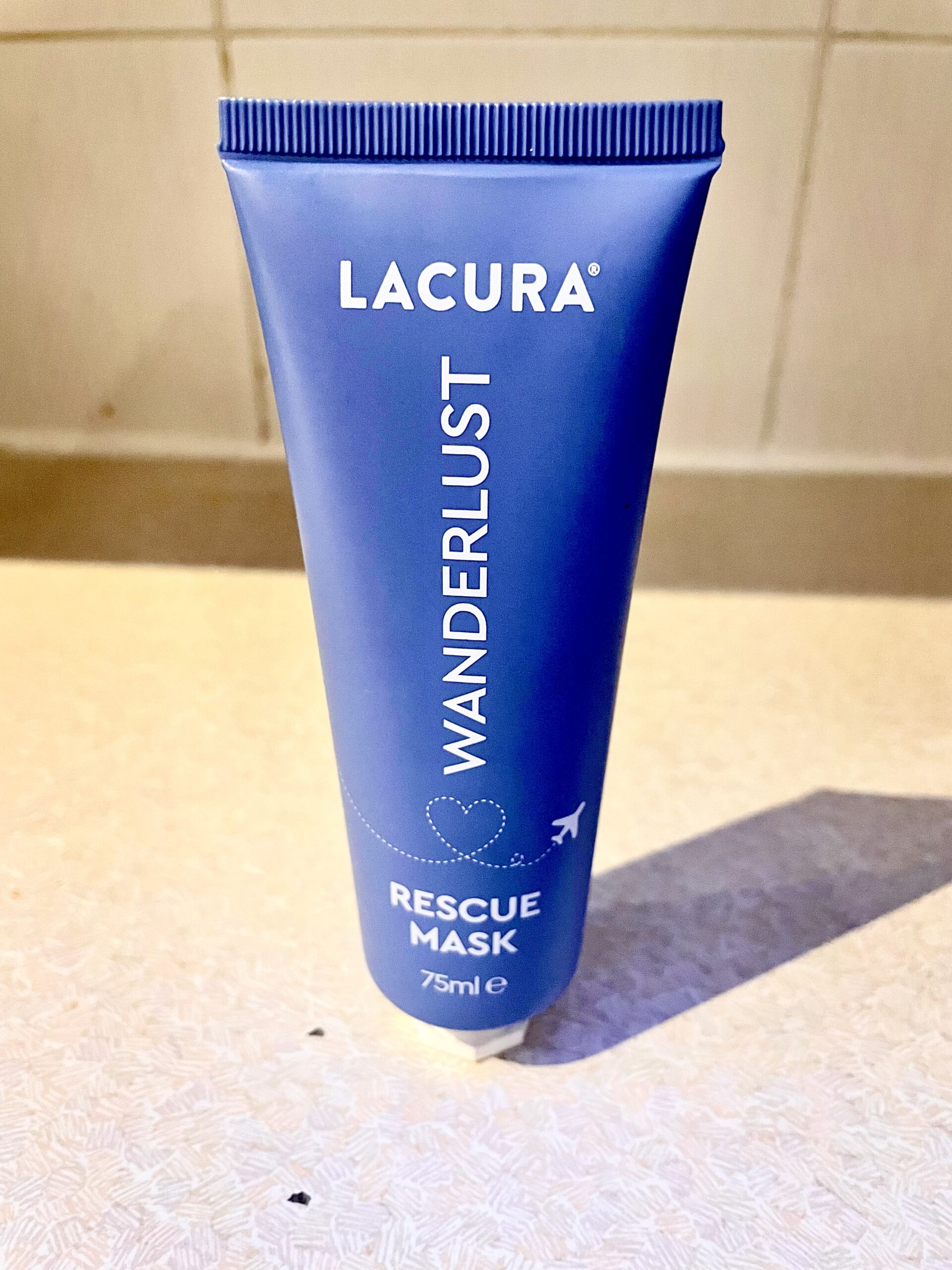 I'm Always Lusting After Soft & Smooth Skin | Aldi Lacura Weekend Mode Exfoliating Mask & Wonderlust Rescue Mask A tall conical bright turquoise plastic tube with a white plastic lid that has Aldi Wonderlust Rescue Mask written in bold white writing on it, on a white background.