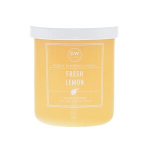 A tall cylindrical clear glass jar full of some bright yellow wax with a white plastic lid and a bright yellow label that has DW Home Candles Fresh Lemon written in bold white writing on it, on a white background.