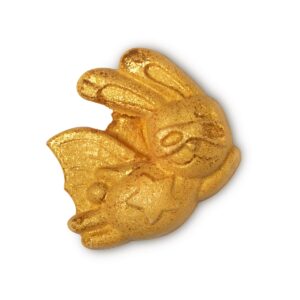 A large bright gold flying rabbit shaped bubble bar that’s covered in some gold lustre, on a white background.