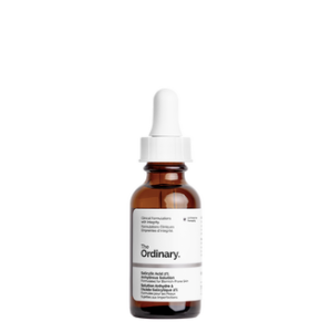 A short cylindrical brown glass bottle with a white rubber pipette lid and a white label that has The Ordinary Salicylic Acid 2% Anhydrous Solution written in bold black writing on it, on a white background.