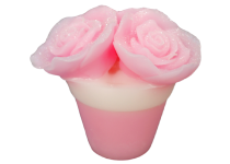 A short cylindrical gradient light pink and white flower pot shaped block of soap that has some large bright pink rose petals coming out of the top of it, on a white background.