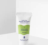 A short conical white plastic tube that has By Beauty Bay Soothe Paste Blemish Treatment with Salicylic Acid and Prebiotic written in dark blue writing and a picture of a bright green stripe on it, on a white background.