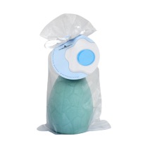 A large bright blue egg shaped block of soap inside a large bright blue Organza Bag with a bright blue label that has The Yorkshire Soap Company Candy Floss Easter Egg Soap written in bold black writing and a picture of a large fried egg with a bright blue yolk on it, on a white background.