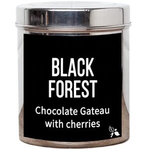 A short cylindrical silver metal tin with a black label that has bird & blend tea company Black Forest Loose Leaf Tea written in bold white writing on it, on a white background.
