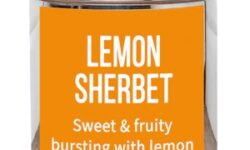A short cylindrical silver metal tin with a golden yellow label that has bird & blend tea company Lemon Sherbet Loose Leaf Tea written in bold white writing on it, on a white background.