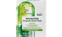 A tall rectangular white plastic pouch that has Garnier SkinActive Niacinamide Detox Ampoule Sheet Mask written in bold black writing and a picture of a large gradient bright green Tablet on it, on a white background.