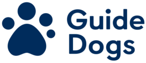 A picture of a large white dogs paw that has Guide Dogs written in bold white writing underneath it on a bright blue background.