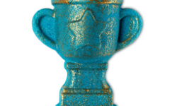 A large dark blue trophy shaped bubble bar that's covered in some silver lustre and has a large silver star engraved on it, on a white background.