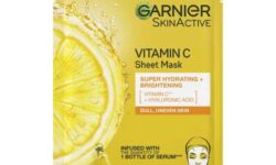 A tall rectangular white plastic pouch that has Garnier SkinActive Vitamin C Sheet Mask written in bold black writing and a picture of a bright yellow slice of Lemon on it, on a white background.