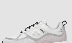 A pair of black mesh trainers with some bright white laces, on a white background.