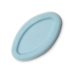 A small oval shaped block of pale blue solid Facial Oil, on a white background.
