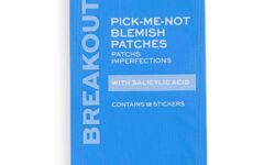 A small rectangular dark blue cardboard Box that has Revolution Skincare Pick-Me-Not Blemish Patches written in bright white writing on it, on a white background.