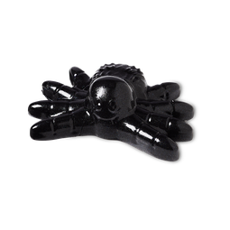 A large shiny Black tarantula shaped Block of Shower Jelly that has a smily face engraved on it, on a white background.