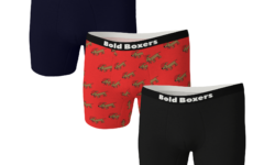 A pair of folded up black boxers with a black waistband that has Bold Boxers written in bold white writing on it next to a pair of folded up navy boxers that has Bold Boxers written in bold white writing on it, and a pair of bright red boxers with a black waistband that has Bold Boxers written in bold white writing on it, on a white background.