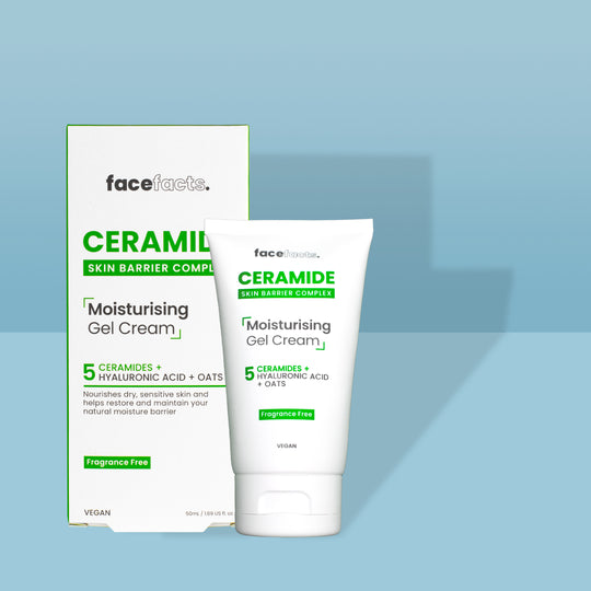 A tall conical white plastic tube with a white plastic lid and a white label that has Face Facts Ceramide Moisturising Gel Cream written in bold black writing on it next to a tall rectangular white cardboard box that has Face Facts Ceramide Moisturising Gel Cream written in bold black writing on it, on a white background.