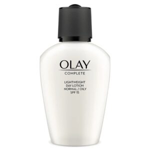 A short teardrop shaped clear plastic bottle full of some creamy white liquid with a black plastic lid and a clear label that has Olay Complete Lightweight 3 in 1 Day Fluid SPF15 written in bold black writing on it, on a white background.