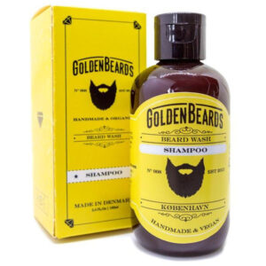 A short cylindrical Black Plastic Bottle with a Black Plastic Lid and a bright yellow label that has Golden Beards Beard Wash Shampoo written in bold white writing and a picture of a beard on it, on a white background.