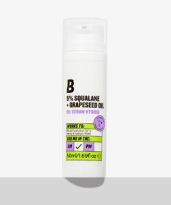 A short cylindrical white plastic Bottle with a clear plastic lid and a white label that has By Beauty Bay written in bold black writing and 5% Squalane + Grapeseed Oil Serum Hybrid written in dark purple writing on it, on a white background.