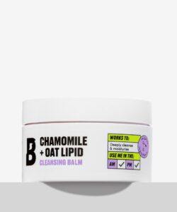 A short cylindrical white plastic tub with a white label that has By Beauty Bay written in bold black writing, Chamomile + Oat Lipid Cleansing Balm written in dark purple writing, and a picture of a black letter B on it, on a white background.