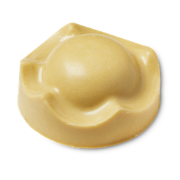 Those Are A Few Of My Favourite Things | Lush Fan Favourites Range | Gifted A large golden caramel crown shaped block of solid body butter that has a large dome coming out of the top of it, on a white background.