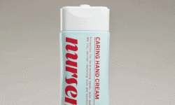 A tall rounded rectangular conical pale blue plastic tube with a white plastic lid that has Nursem Caring Hand Cream written in bright Red writing on it, on a white background.