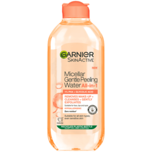 A tall rounded rectangular bright peachy pink plastic bottle with a bright peachy pink plastic lid that has Garnier SkinActive written in bold black writing and Micellar Gentle Peeling Water written in dark pink writing on it, on a white background.