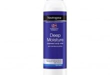 A tall cylindrical metallic white can with a dark purple plastic lid and a dark purple label that has Neutrogena® Norwegian Formula Deep Moisture Express Body Mist written in bright white writing on it, on a white background.