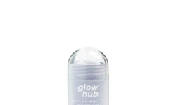 A tall cylindrical clear plastic twist up tube with a light purple dial and a clear frosted label that has Glow Hub Purify & Brighten Face Mask Stick written in bright white writing on it, on a white background.