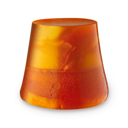 A short dark brown cylindrical block of shower jelly that has some pieces of Silver lustre running through it, on a white background.