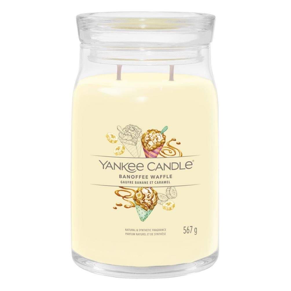 Going For Another Nice Walk In The Park | Yankee Candle Art In The Park Continued Collection A tall cylindrical glass jar full of some creamy white wax with a label that has Yankee Candle written in white writing, Banoffee Waffle written in black writing, and a picture of some scoops of Banana Ice Cream and some pieces of some broken up waffle cone on it, on a white background..