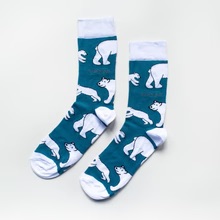 A pair of some cyan blue socks with some white toes and heels that has some pictures of some bright white polar bears on them, on a white background.