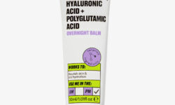 A short cylindrical white plastic tube with a metallic white lid that has By Beauty Bay written in bold black writing and 5% Squalane, Hyaluronic Acid + Polyglutamic Acid Overnight Balm written in dark purple writing on it, on a white background.