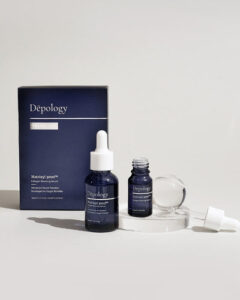 A short cylindrical translucent blue Glass bottle with a white rubber pipette lid that has Depology Matrixyl 3000 Collagen Boosting Serum written in bright white writing on it next to a miniature translucent blue glass bottle with a white rubber pipette lid that has Depology Matrixyl 3000 Collagen Boosting Serum written in bright white writing on it and a medium rectangular light blue cardboard box that has Depology Matrixyl 3000 Collagen Boosting Serum Travel Set written in bright white writing on it, on a white background.