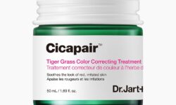 A short cylindrical clear Glass Jar full of some dark green liquid with a white metallic lid and a white label that has Dr. Jart+ written in bold black writing and Cicapair™ Tiger Grass Colour Correcting Treatment written in bright pink writing on it, on a white background.