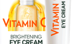 A long and thin conical gradient bright white and yellow plastic tube with a white plastic lid that has Garnier SkinActive Brightening Eye Cream written in bold black writing and Vitamin C written in bright orange writing on it, on a white background.