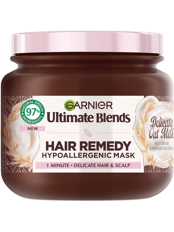 I've Think That I've Found The Remedy To Dry & Delicate Hair | Garnier Ultimate Blends Delicate Oat Milk Hair Remedy Hypoallergenic Mask | Gifted A short cylindrical brown Plastic Tub with a metallic pink Plastic Lid and a metallic pink label that has Garnier Ultimate Blends Delicate Oat Milk Hair Remedy Hypoallergenic Mask written in bold black writing on it, on a white background.
