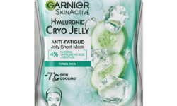 A tall rectangular shiny silver plastic pouch that has Garnier SkinActive Anti-Fatigue Hyaluronic Acid & Icy Cucumber Face Mask written in bold black writing and a picture of a slice of bright green Cucumber and some cubes of white ice on it, on a white background.